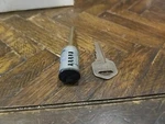 Kwikset Smartkey Deadbolt Cylinder Replacement 1 Key- Black Facing Front 83373. Fixed Price $10.50.