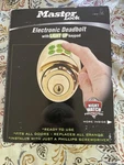 Master Lock Electronic Keyless Deadbolt With Light Up Pad Gold. Fixed Price $80.00.