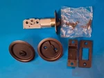 Kwikset 335 11P Rnd Pckt Dr Lck, Round Pocket Door Lock, Venetian Bronze. Fixed Price $24.20.
