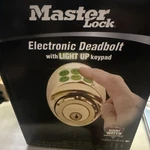 Master Lock Electronic Keyless Deadbolt With Light Up Pad Gold. Fixed Price $59.99.