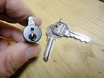 Kwikset Smartkey Deadbolt Cylinder Replacement Bronze Facing Front. Fixed Price $13.00.